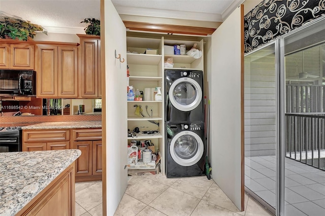 clothes washing area with stacked washer / dryer, crown molding, light tile patterned flooring, and a textured ceiling