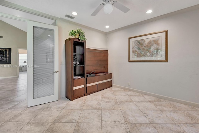 interior space with crown molding and ceiling fan