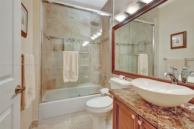 full bathroom featuring tile patterned flooring, vanity, bath / shower combo with glass door, and toilet