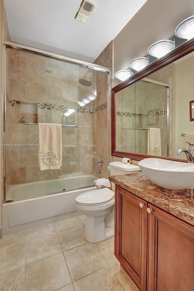 full bathroom with tile patterned floors, vanity, toilet, and enclosed tub / shower combo