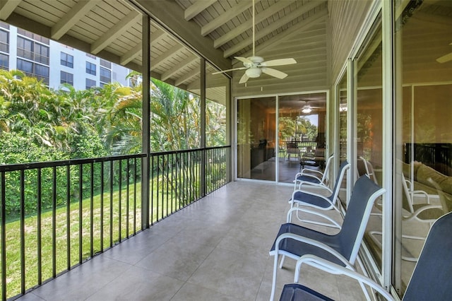 sunroom / solarium with vaulted ceiling with beams and ceiling fan