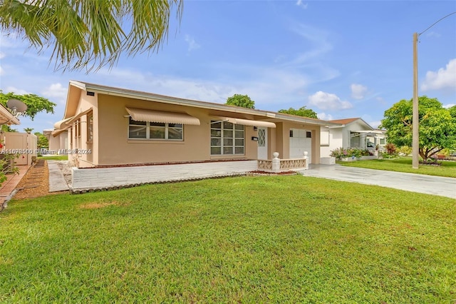 ranch-style house featuring a garage and a front lawn