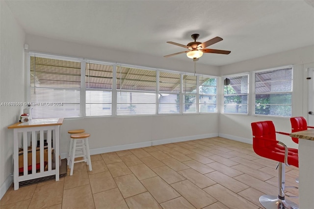 sunroom featuring ceiling fan