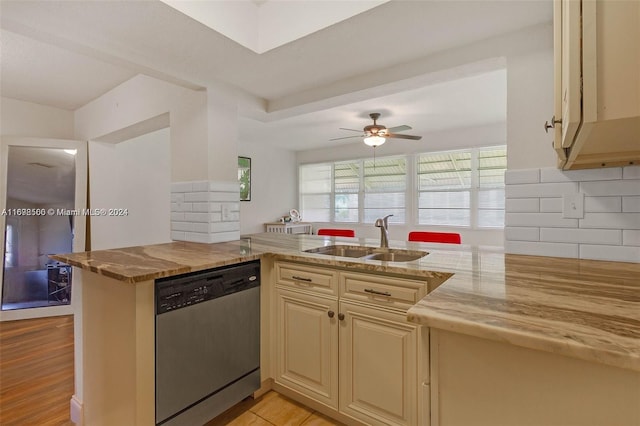 kitchen featuring kitchen peninsula, cream cabinets, sink, and stainless steel dishwasher