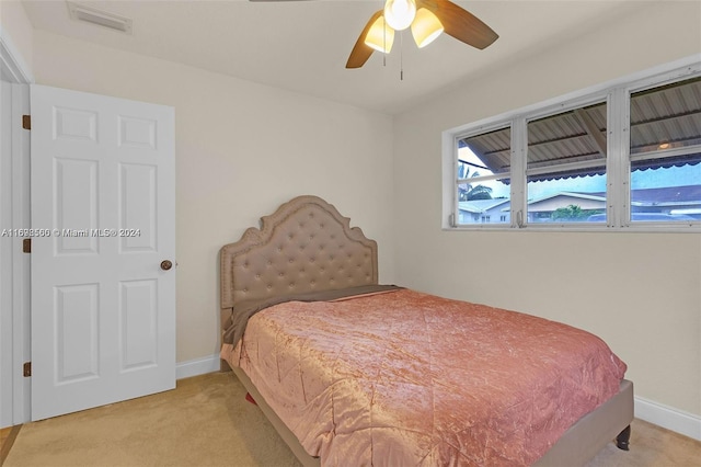 bedroom with light colored carpet and ceiling fan