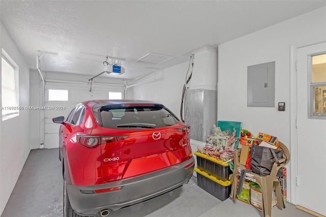 garage with electric panel and a garage door opener