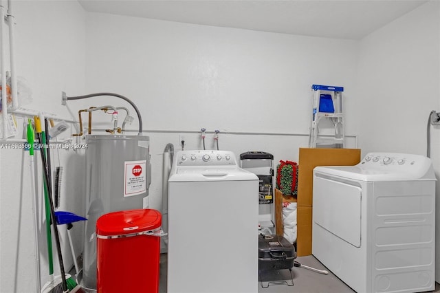 laundry room featuring water heater and independent washer and dryer