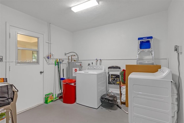 washroom with independent washer and dryer, a textured ceiling, and water heater