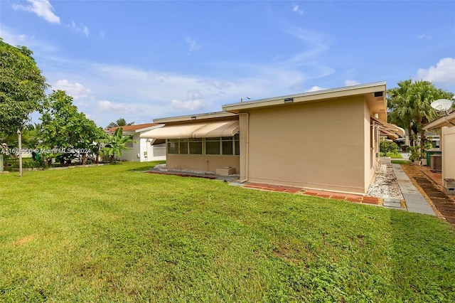 back of property featuring a lawn