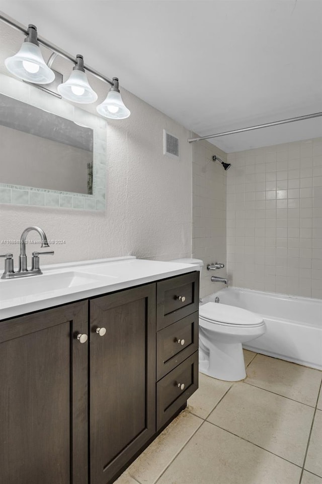 full bathroom with tile patterned flooring, vanity, toilet, and tiled shower / bath