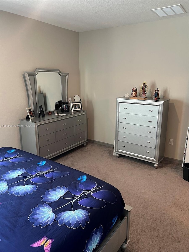 carpeted bedroom featuring a textured ceiling