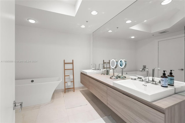 bathroom featuring a washtub, vanity, and tile patterned flooring