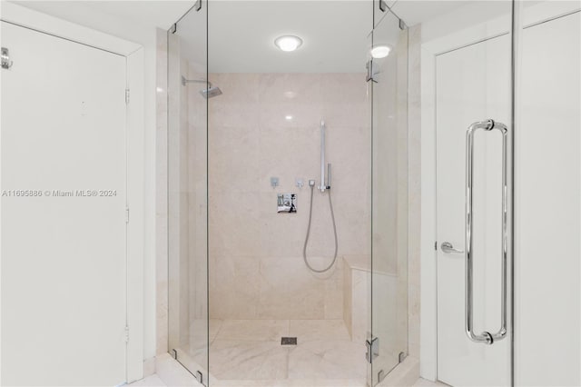 bathroom with a shower with door