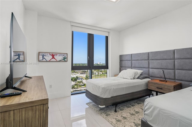 tiled bedroom featuring expansive windows