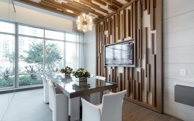 dining space with hardwood / wood-style flooring and a notable chandelier