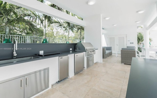 view of patio with an outdoor living space, area for grilling, and sink