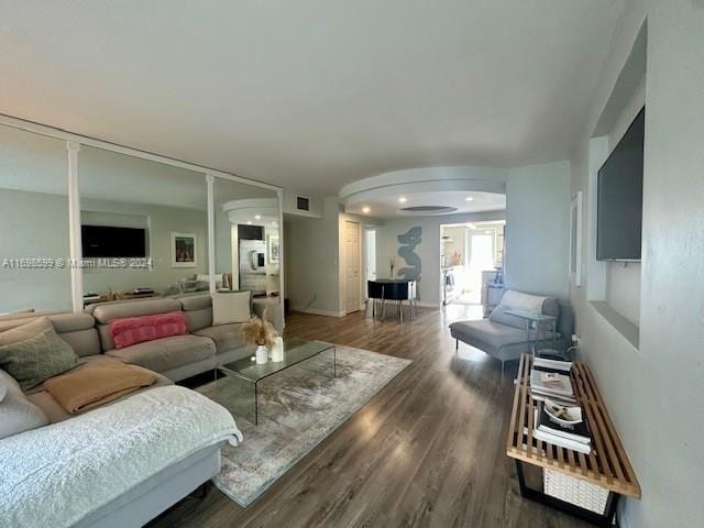 living room featuring dark wood-type flooring