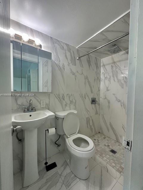 1065 98th St Unit 2, Bay Harbor Islands, FL 33154 - bathroom featuring marble look tile flooring, toilet, a marble finish shower, and a sink