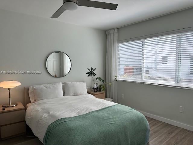 bedroom with ceiling fan and hardwood / wood-style floors