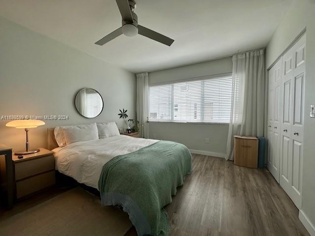1065 98th St Unit 2, Bay Harbor Islands, FL 33154 - bedroom featuring wood finished floors, baseboards, a closet, and a ceiling fan