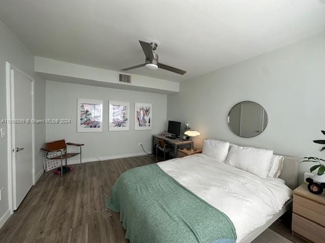 bedroom with dark hardwood / wood-style flooring and ceiling fan