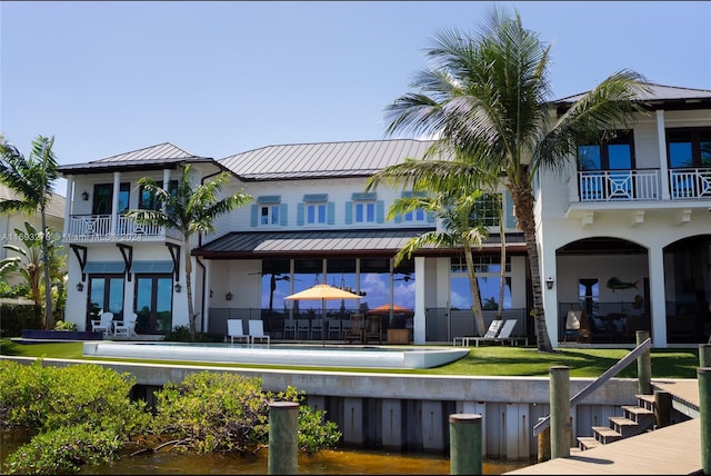 rear view of house featuring a patio area and a balcony