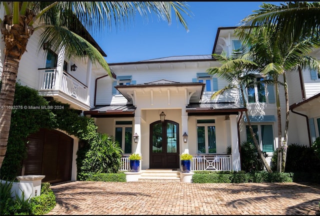 view of front of property featuring covered porch and french doors