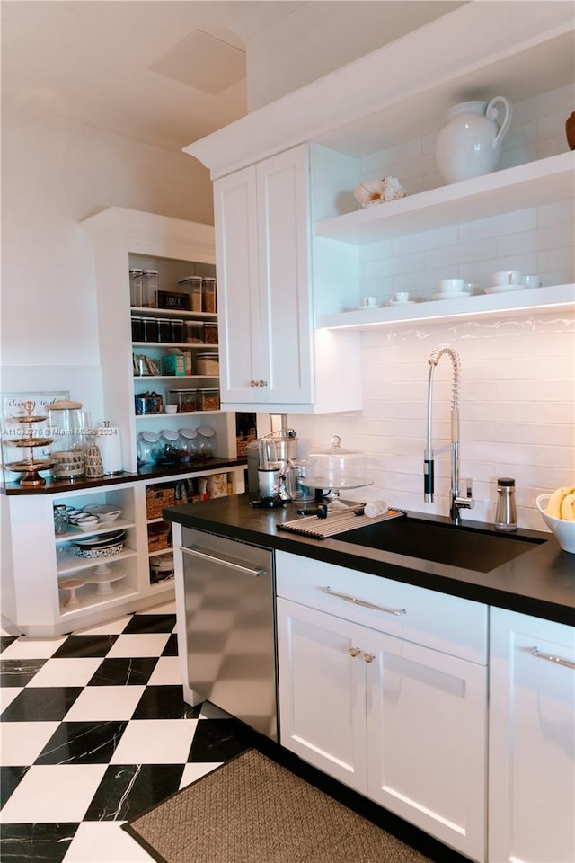 bar featuring decorative backsplash, sink, white cabinets, and stainless steel dishwasher