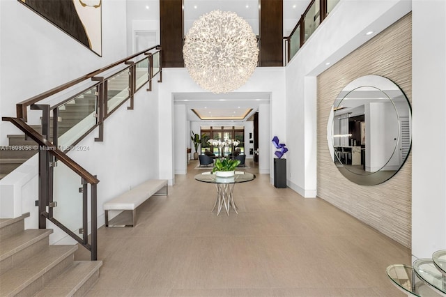 foyer entrance with a towering ceiling and an inviting chandelier