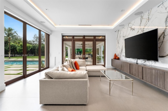 living room featuring french doors and a raised ceiling