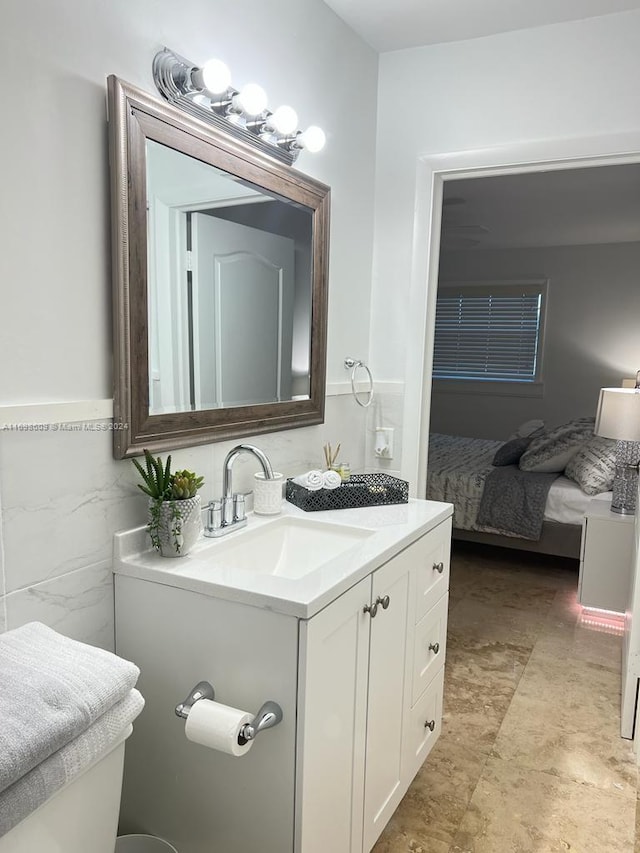 bathroom featuring vanity and tile walls