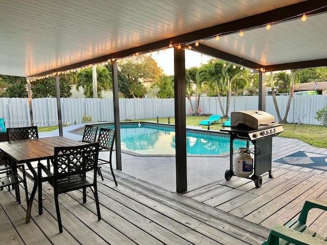 view of swimming pool featuring a deck and grilling area