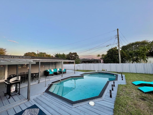 view of swimming pool with an outdoor living space, area for grilling, a yard, and a wooden deck