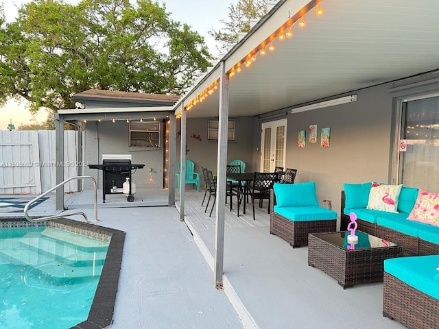 view of patio featuring a fenced in pool, outdoor lounge area, and a grill