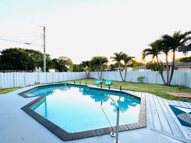 view of pool with a lawn