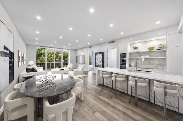 dining room with light hardwood / wood-style floors and sink