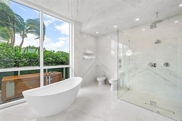 bathroom featuring separate shower and tub, tile walls, and a bidet