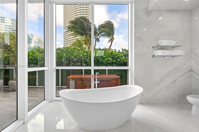 bathroom featuring a bathing tub and a bidet