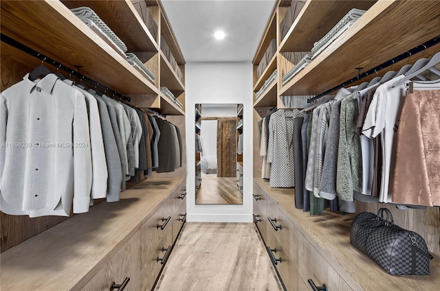 spacious closet featuring light hardwood / wood-style floors