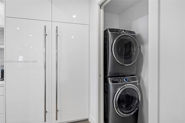 washroom featuring stacked washer and clothes dryer