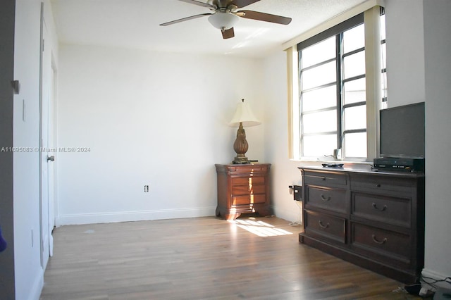 bedroom featuring ceiling fan and dark wood-type flooring