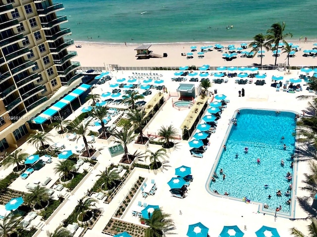 birds eye view of property featuring a water view and a view of the beach