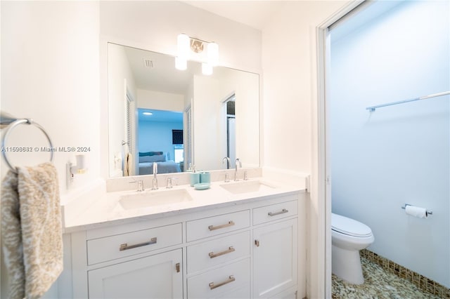 bathroom with tile patterned flooring, vanity, and toilet