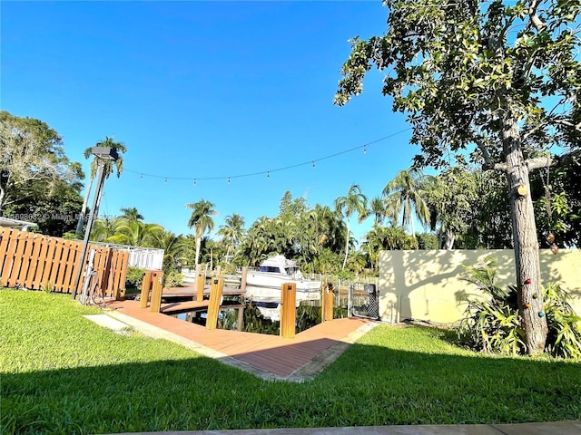 view of yard with a boat dock and a water view