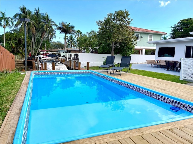 view of swimming pool featuring a deck