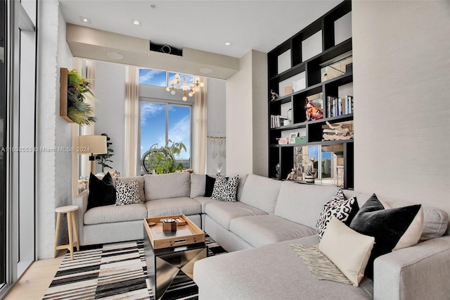 living room featuring a chandelier and light wood-type flooring