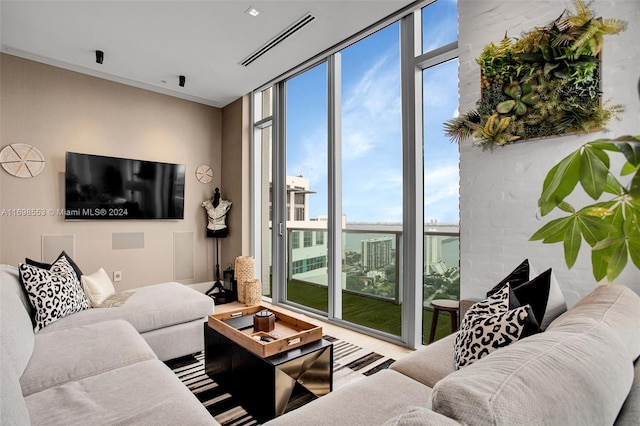 living room with floor to ceiling windows and a healthy amount of sunlight