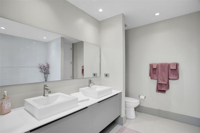 bathroom with tile patterned floors, vanity, and toilet