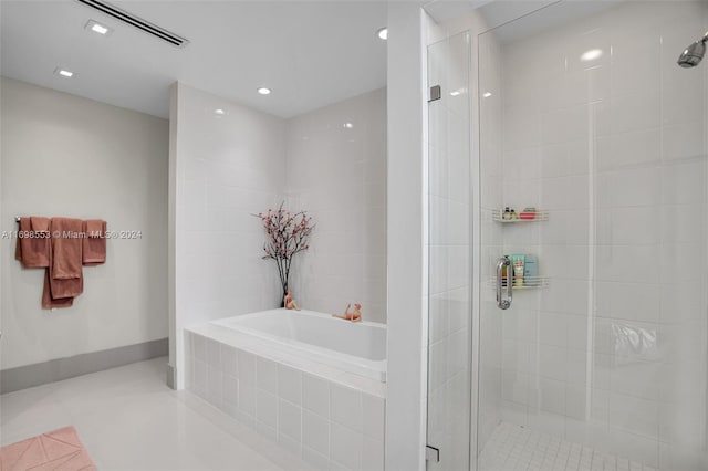 bathroom with shower with separate bathtub