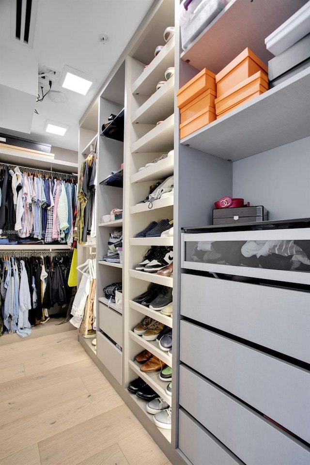 walk in closet featuring light hardwood / wood-style flooring